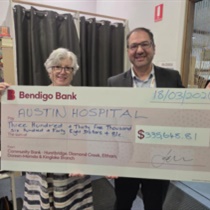 Diamond Creek Opportunity Shop Treasurer, Roslyn Gaylor, presents cheque to Austin Health Chief Financial Officer, Frank Vosnidis
